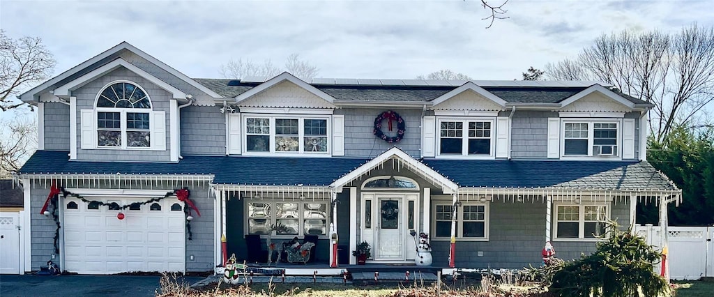 view of front of property with a porch and a garage