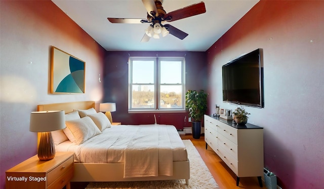 bedroom featuring light wood-type flooring and ceiling fan