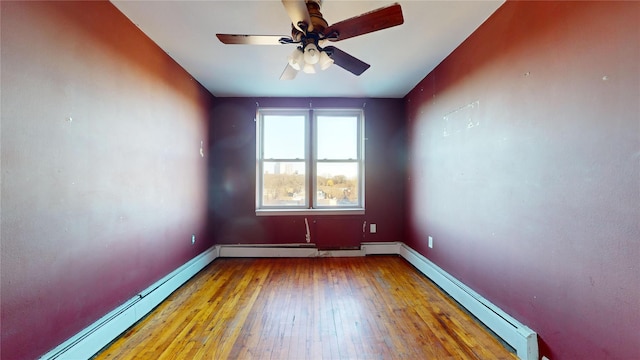 spare room with ceiling fan, light hardwood / wood-style flooring, and a baseboard heating unit