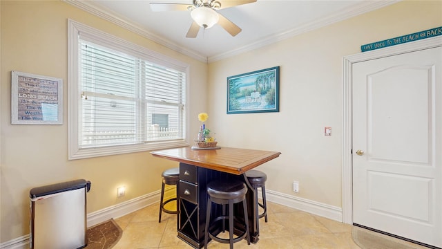 dining room with crown molding, ceiling fan, light tile patterned flooring, and baseboards