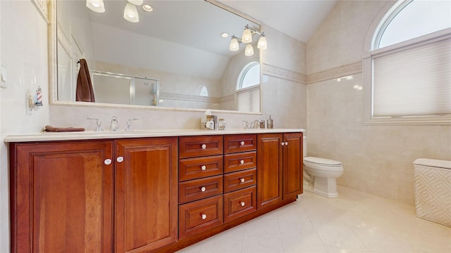 full bath featuring lofted ceiling, double vanity, a sink, and a shower with door