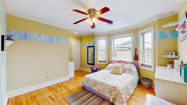 bedroom featuring wood finished floors, a ceiling fan, visible vents, baseboards, and crown molding