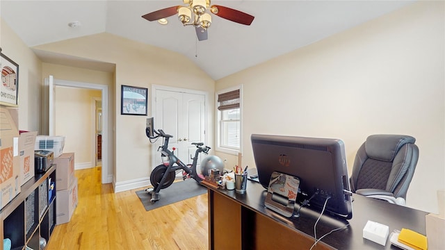 office with ceiling fan, light wood-style flooring, baseboards, and vaulted ceiling