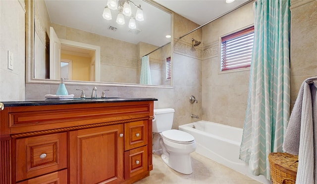 full bath with visible vents, toilet, tile patterned flooring, shower / bathtub combination with curtain, and tile walls