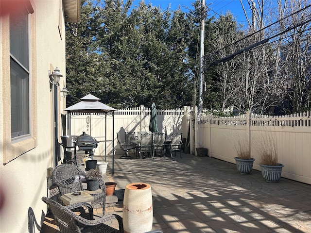 view of patio with outdoor dining area and fence