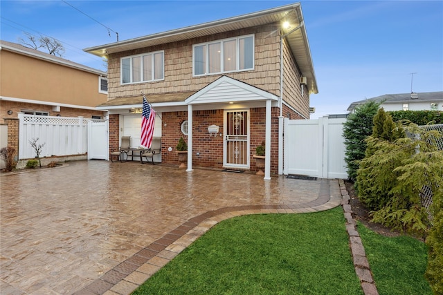 view of front of house featuring a front lawn and a patio