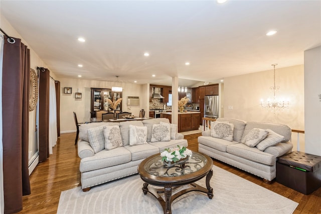 living room with dark hardwood / wood-style floors and a notable chandelier