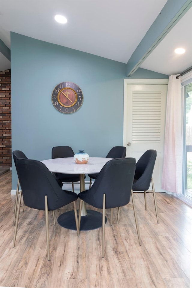 dining space with light hardwood / wood-style floors and plenty of natural light