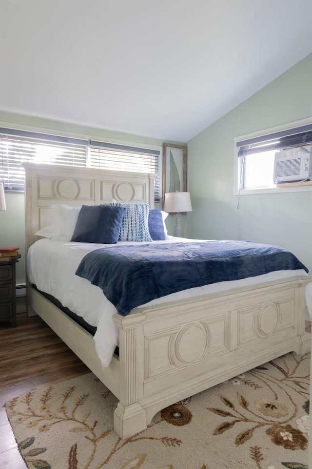 bedroom featuring lofted ceiling, cooling unit, and light wood-type flooring