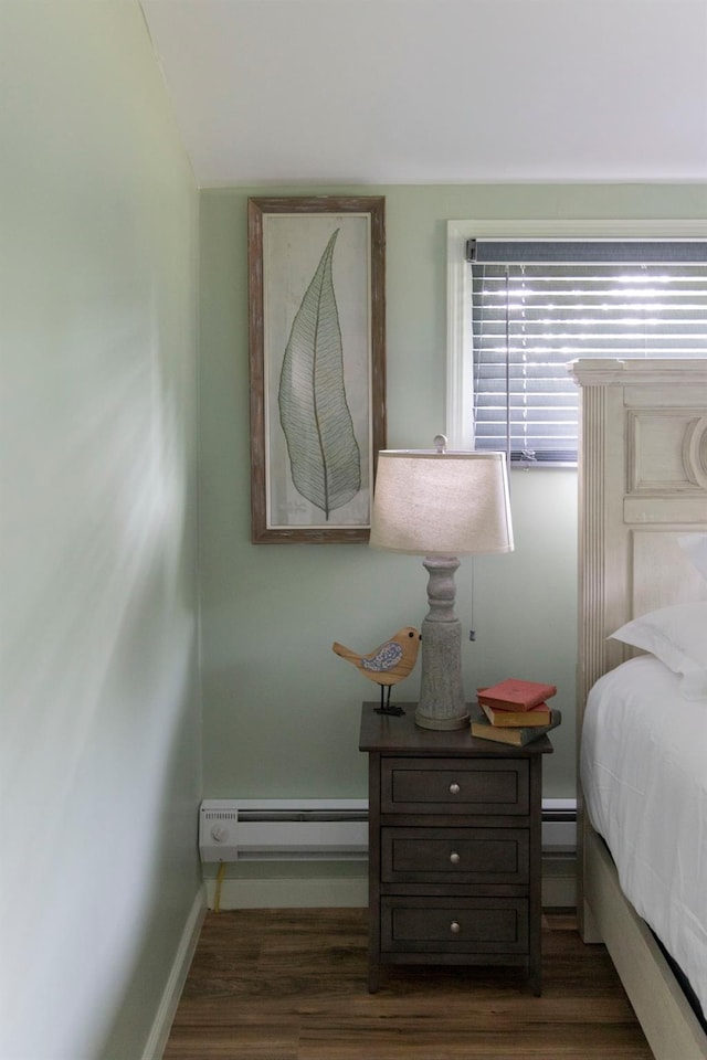 bedroom featuring baseboard heating and dark wood-type flooring