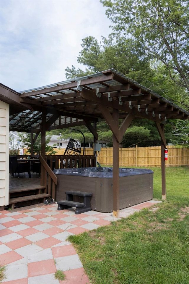 view of patio / terrace with a hot tub and a deck