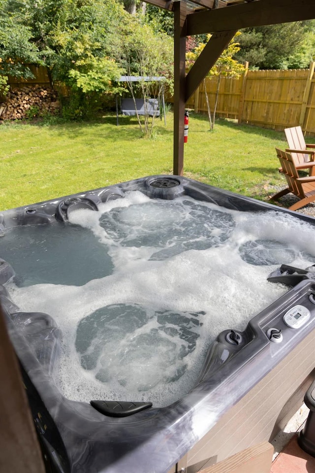 exterior space with a hot tub and a trampoline