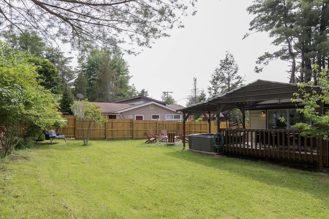 view of yard with a deck and central AC unit