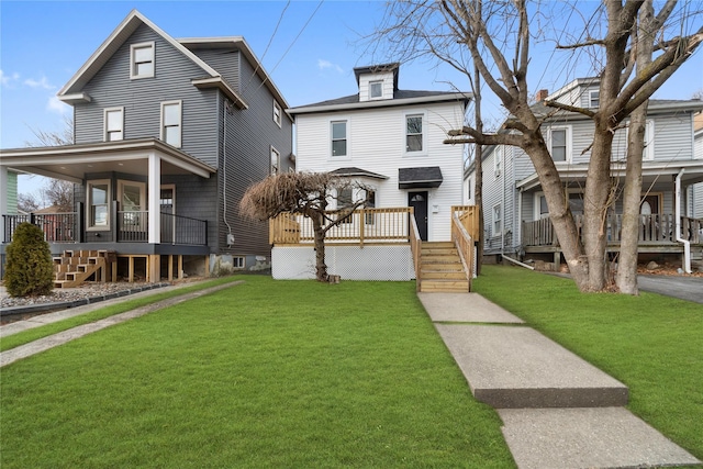 view of front of property featuring a front yard and covered porch