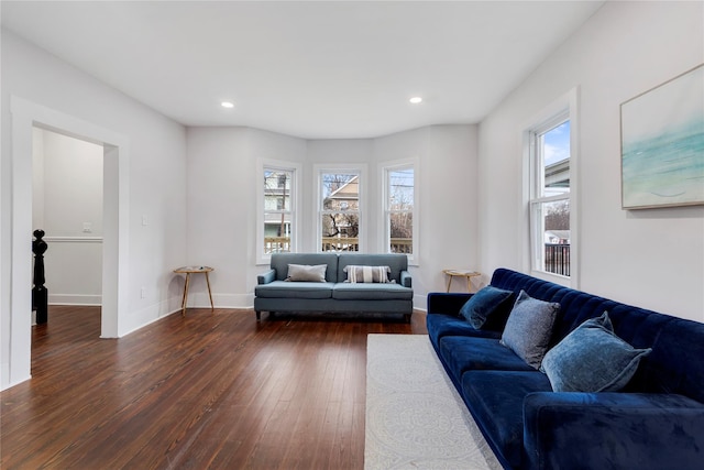 living room featuring a wealth of natural light and dark hardwood / wood-style floors