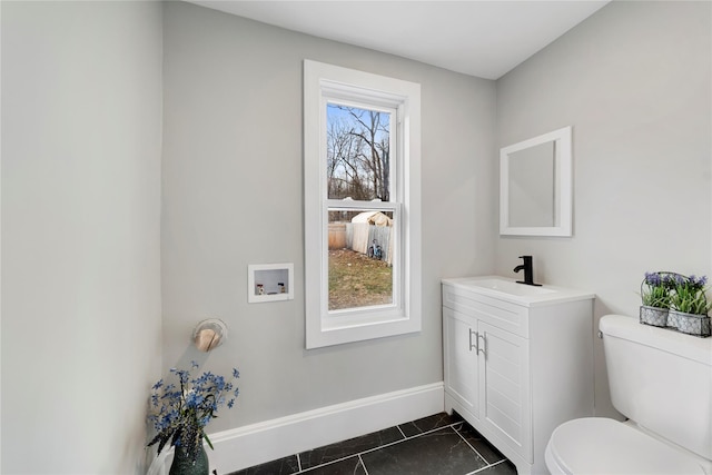 bathroom with toilet, tile patterned flooring, and vanity