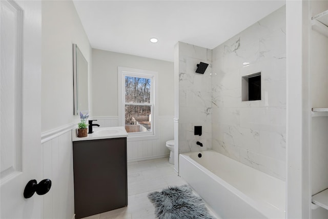 full bathroom with tiled shower / bath combo, vanity, and toilet