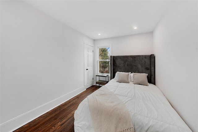 bedroom with dark hardwood / wood-style floors