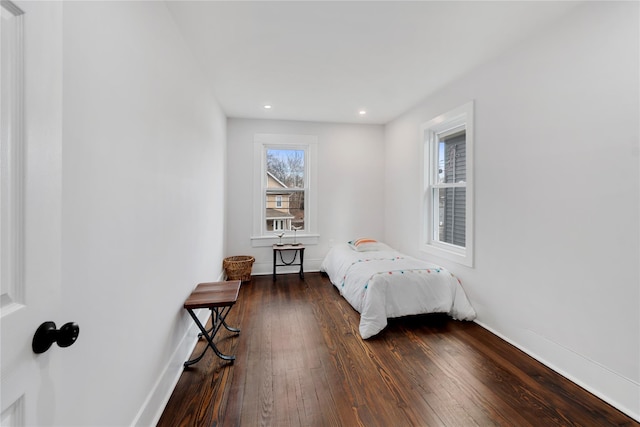 bedroom with dark hardwood / wood-style flooring