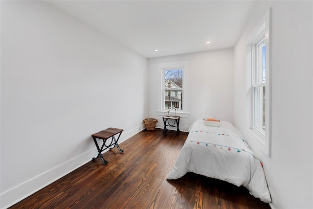 bedroom with dark wood-type flooring