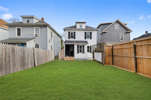 back of house featuring a yard