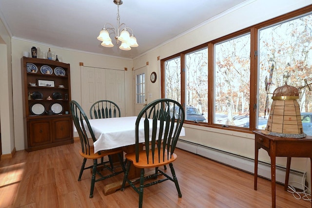 dining space featuring baseboard heating, ornamental molding, light wood-type flooring, and a notable chandelier