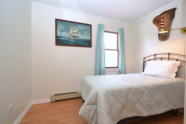 bedroom featuring baseboard heating, crown molding, and light hardwood / wood-style flooring