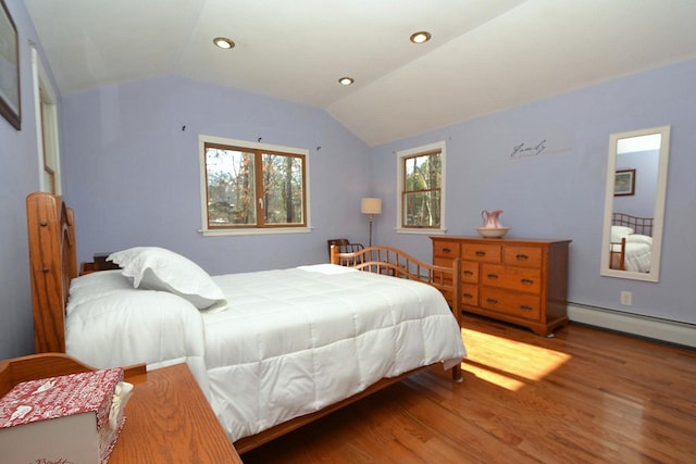 bedroom featuring a baseboard radiator, vaulted ceiling, and hardwood / wood-style floors