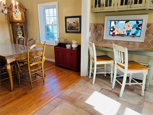 dining space featuring an inviting chandelier and light hardwood / wood-style flooring