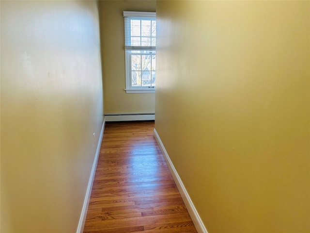 corridor featuring hardwood / wood-style flooring and a baseboard radiator