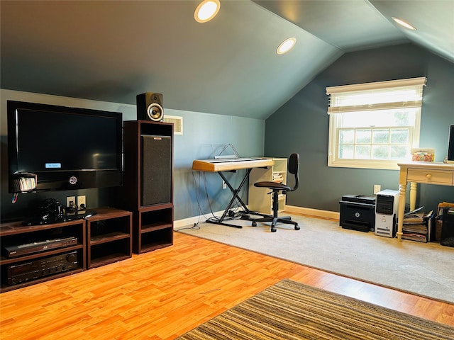 workout room featuring hardwood / wood-style flooring and lofted ceiling