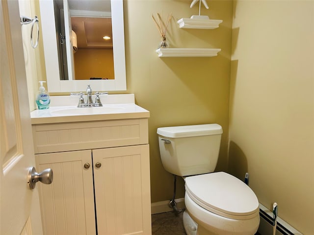 bathroom with vanity, a baseboard heating unit, and toilet