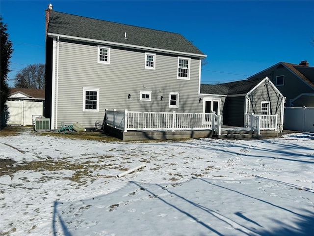 snow covered rear of property featuring a wooden deck