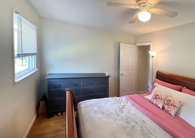 bedroom with ceiling fan and wood-type flooring