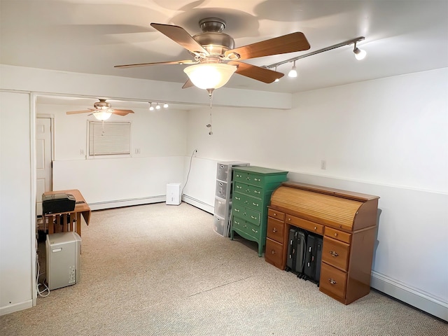 unfurnished office with light carpet, a baseboard heating unit, track lighting, and ceiling fan