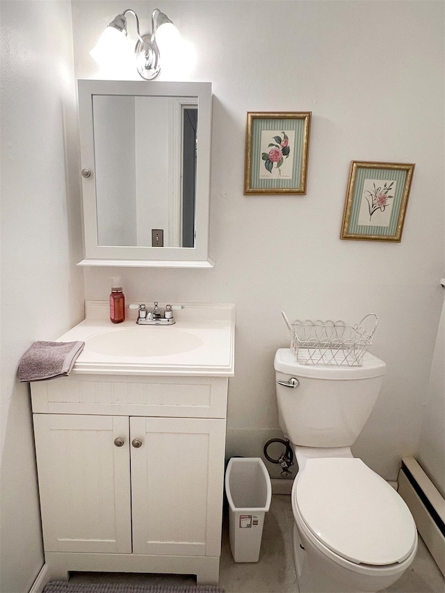 bathroom with baseboard heating, toilet, and vanity