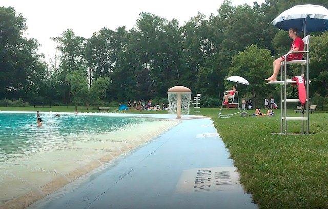 view of pool with a playground and a yard