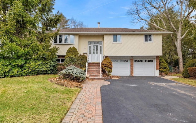 split foyer home featuring a front yard and a garage