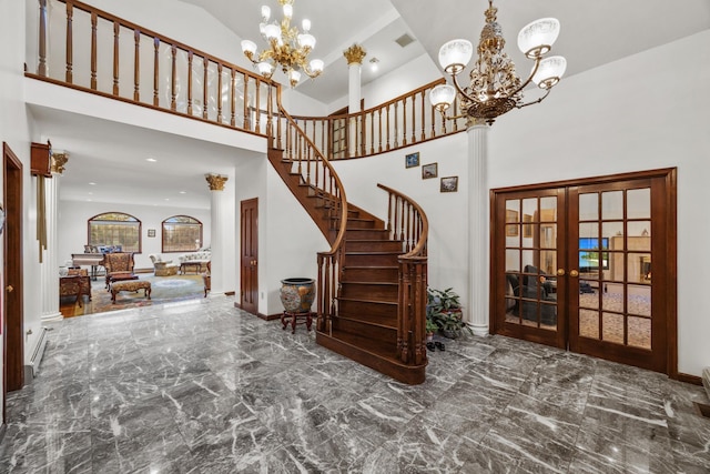 foyer featuring a notable chandelier, french doors, and a high ceiling