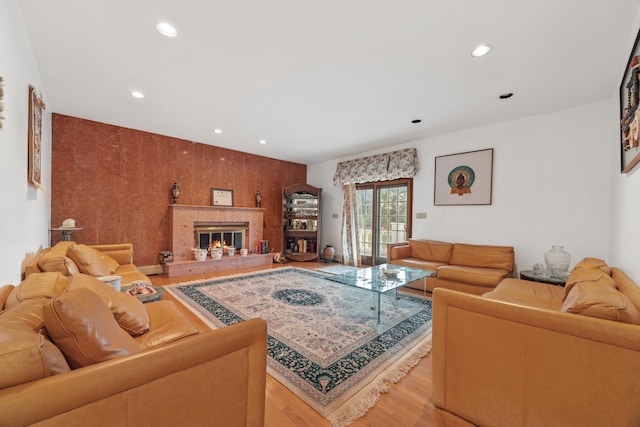 living room featuring a premium fireplace and light wood-type flooring