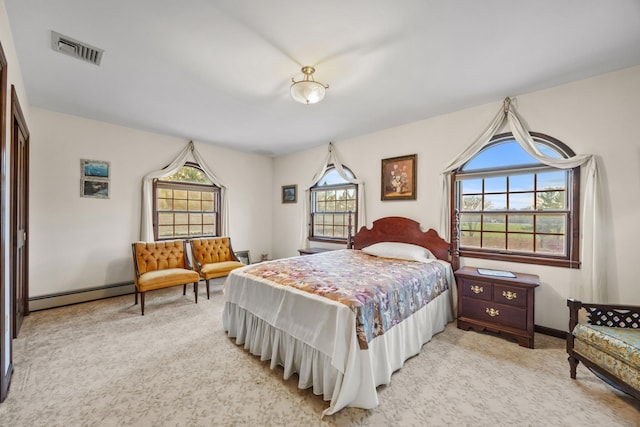 carpeted bedroom featuring baseboard heating