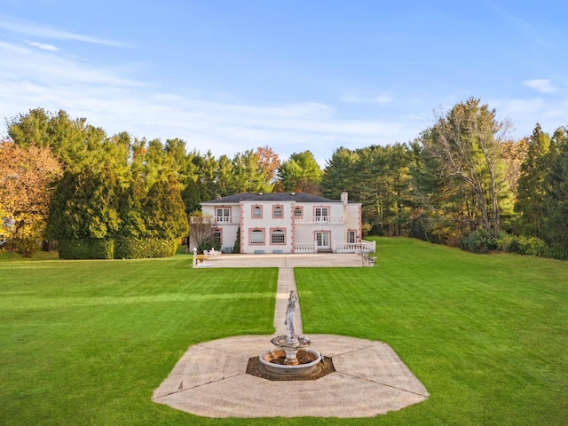 back of house with a patio and a yard