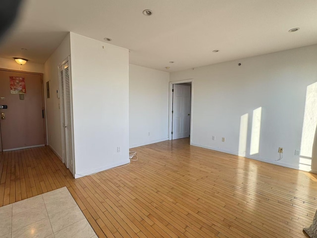 empty room with light hardwood / wood-style floors