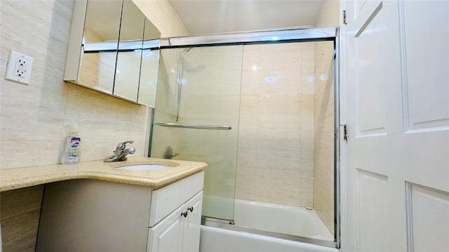 bathroom featuring enclosed tub / shower combo and vanity