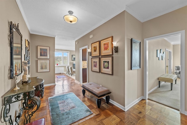 hallway with a textured ceiling, ornamental molding, and parquet floors