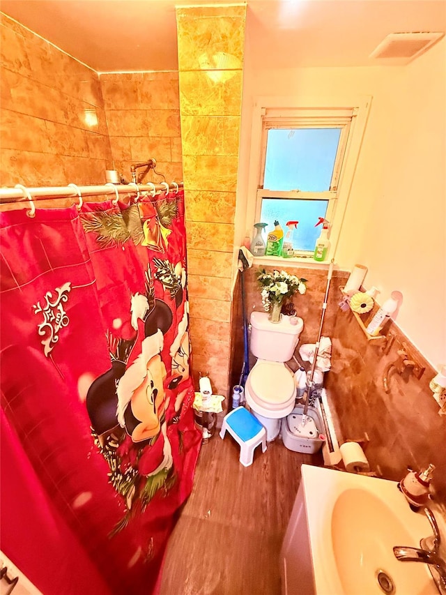 bathroom featuring sink, toilet, and hardwood / wood-style flooring