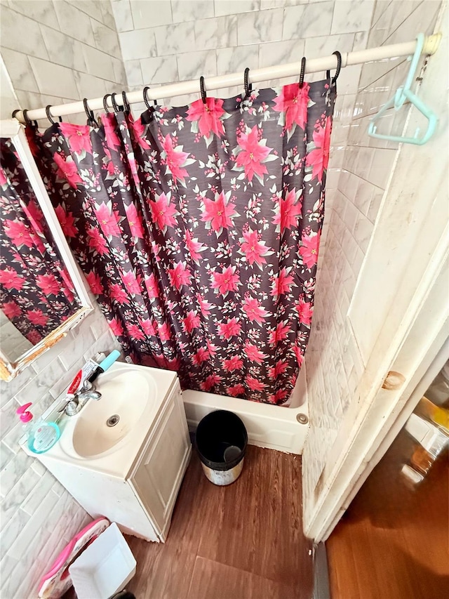 bathroom featuring vanity, wood-type flooring, and walk in shower