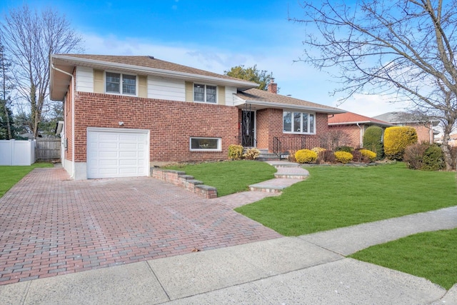 split level home with a front lawn and a garage