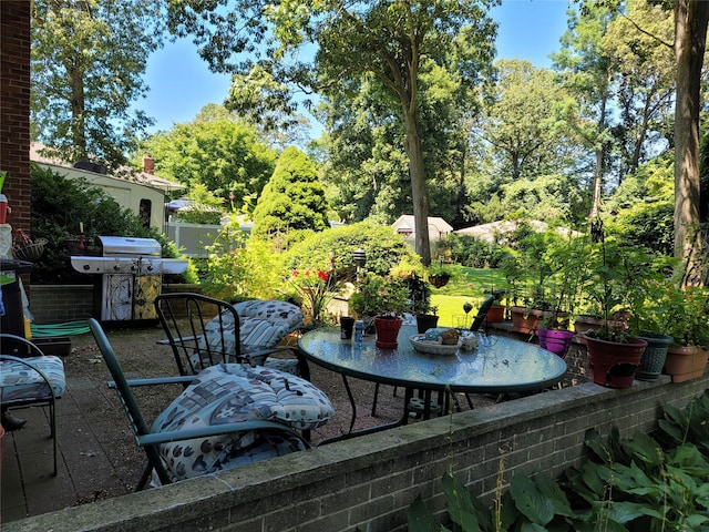 view of patio featuring outdoor dining space and fence