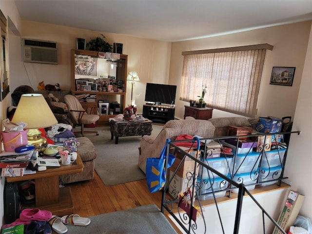 living room with wood finished floors and a wall mounted air conditioner